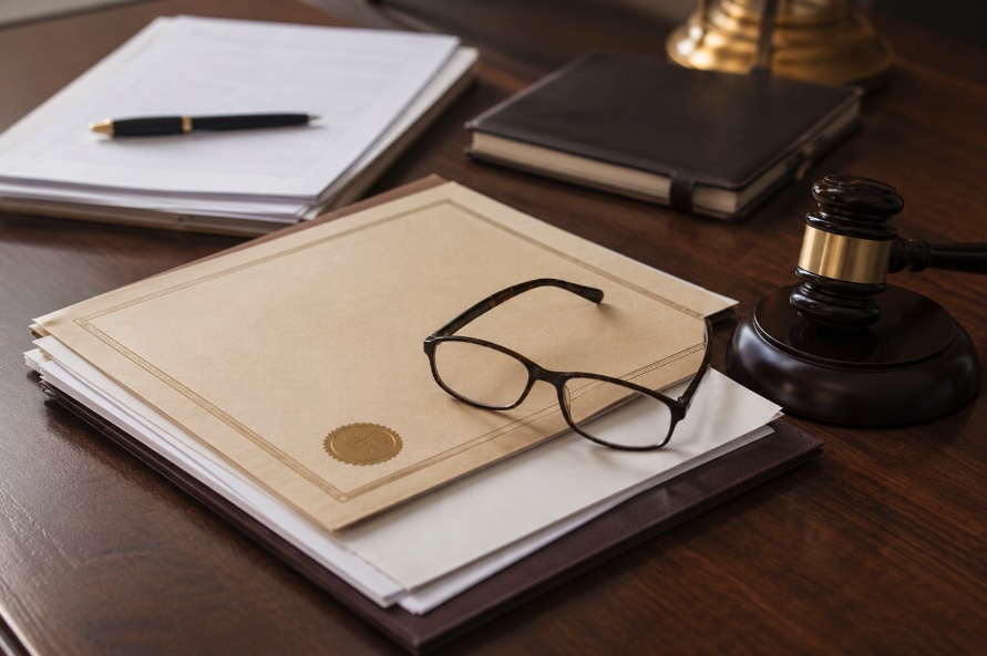 A property deed and legal documents laid out on a desk for ownership review in a New Jersey real estate matter